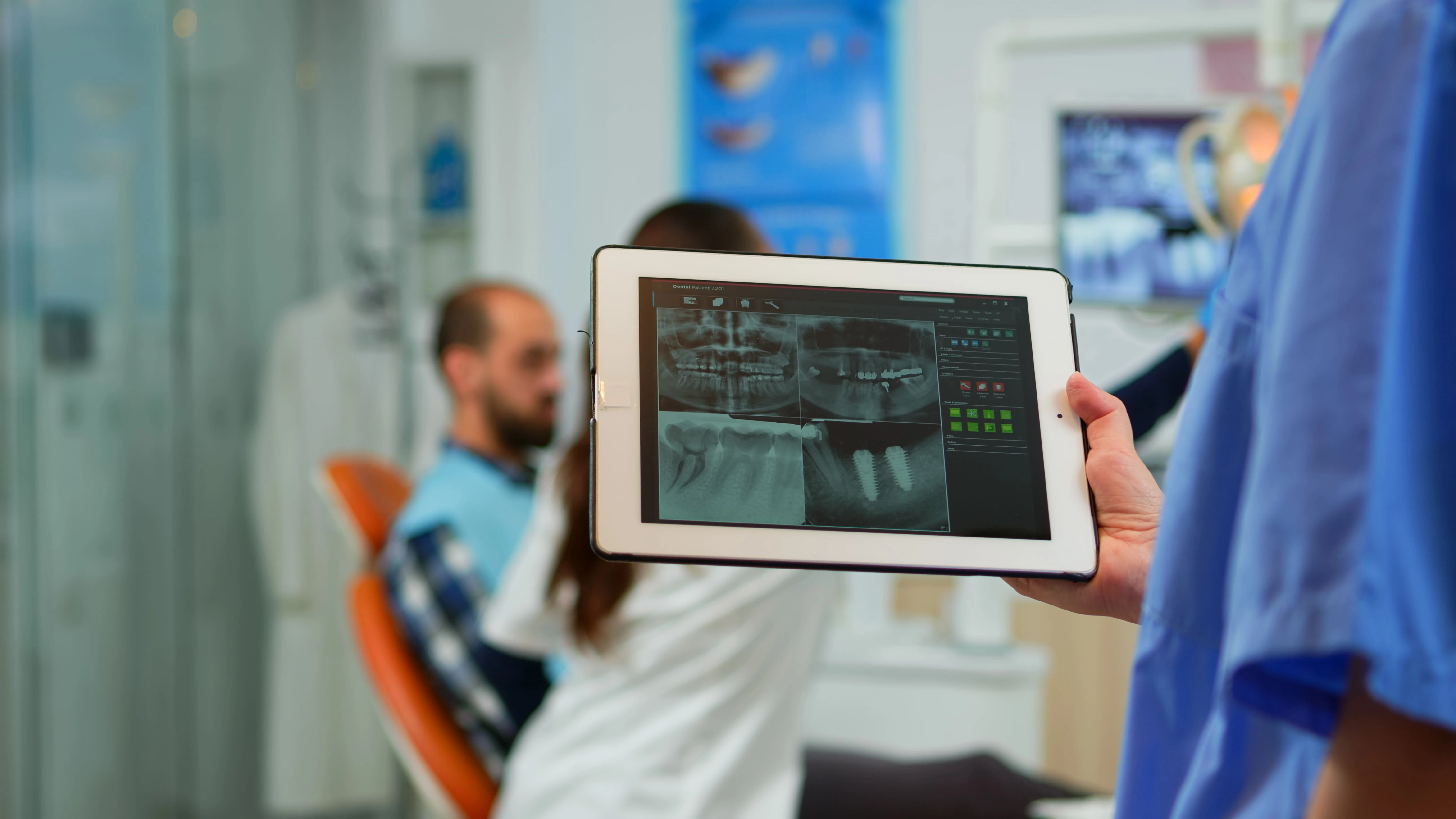 doctor-holding-tablet-displaying-mri-images