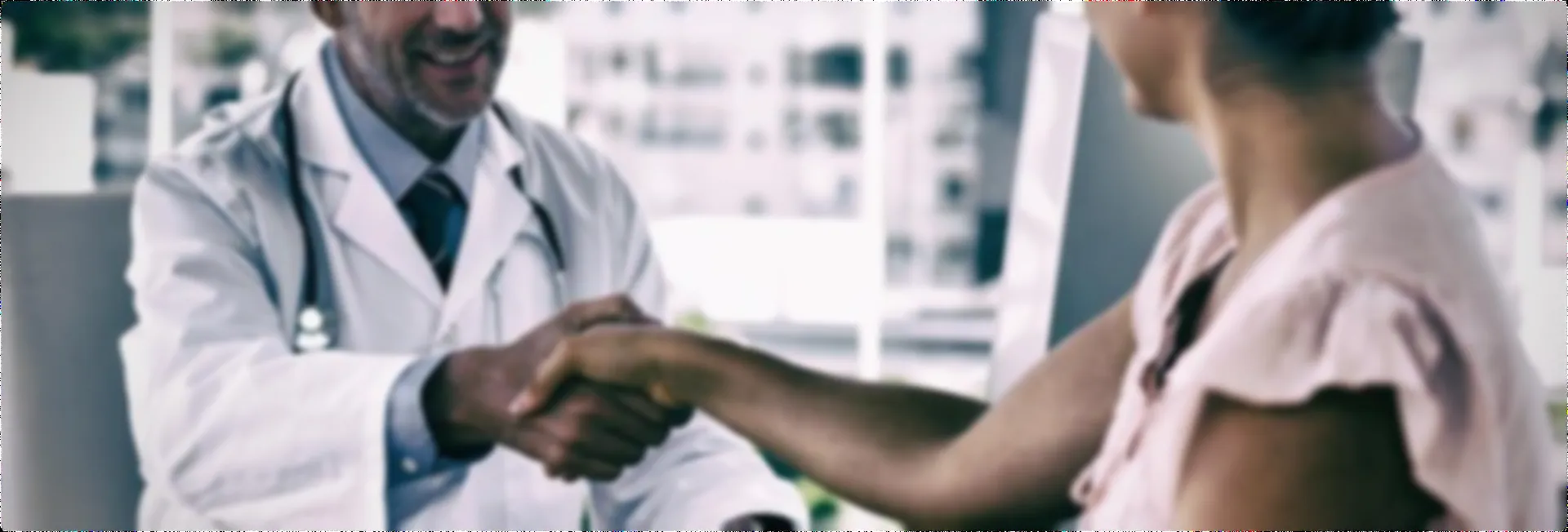 doctor-and-patient-shaking-hands-in-clinical-setting
