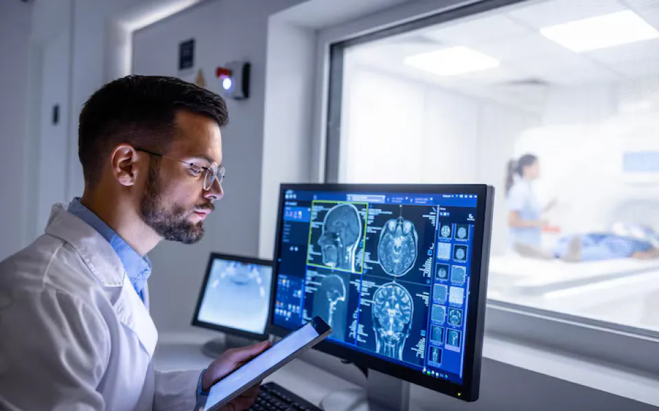 Doctor holding ultrasound sensor, viewing real-time ultrasound images for non-invasive diagnosis.