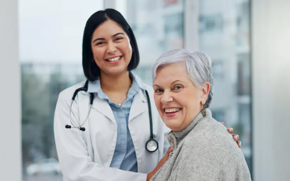 Smiling doctor holding elderly patient’s arms, showcasing Scriptoware’s secure Patient Imaging Dashboard.