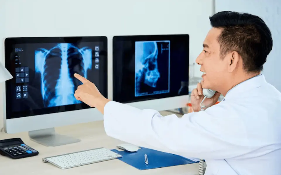 Doctor pointing at a rib cage scan on a screen using Scriptoware's diagnostic imaging platform