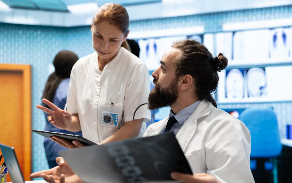 Patient greeted by receptionist at clinic, showing Scriptoware’s personalized care coordination system.